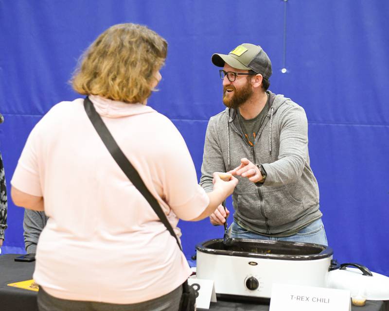 Adam Rex, of Sycamore, serves chili during the Sycamore Park District's Fire and Ice Festival held at the Sycamore Park District Community Center on Saturday, Jan. 13, 2024.