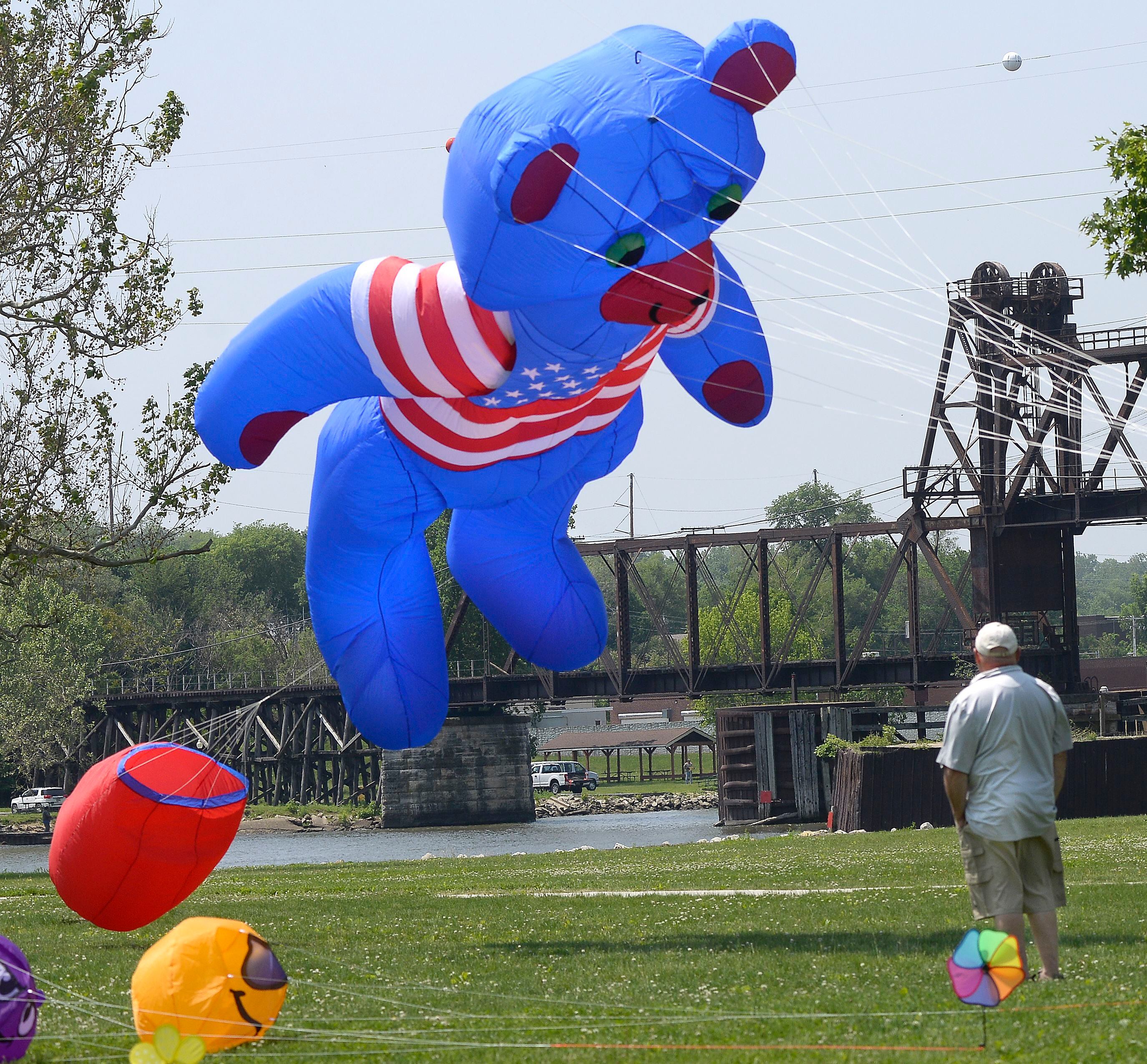 Jim Gates watches his patriotic bear take flight Saturday, May 20, 2023, during the Kites in Flight festival at Riverfront Park in Ottawa. Kite flying as well as other activities took place Saturday and Sunday.