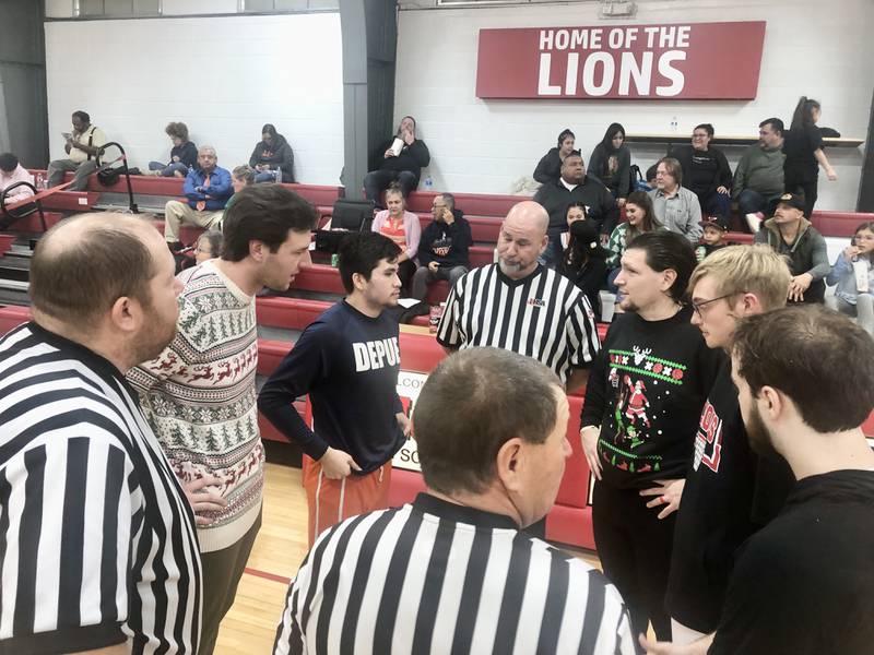 DePue coach Trae Blumhorst (left) and LaMoille coach Chance Blumhorst 
meet with officials and captains before Friday's game in LaMoille.