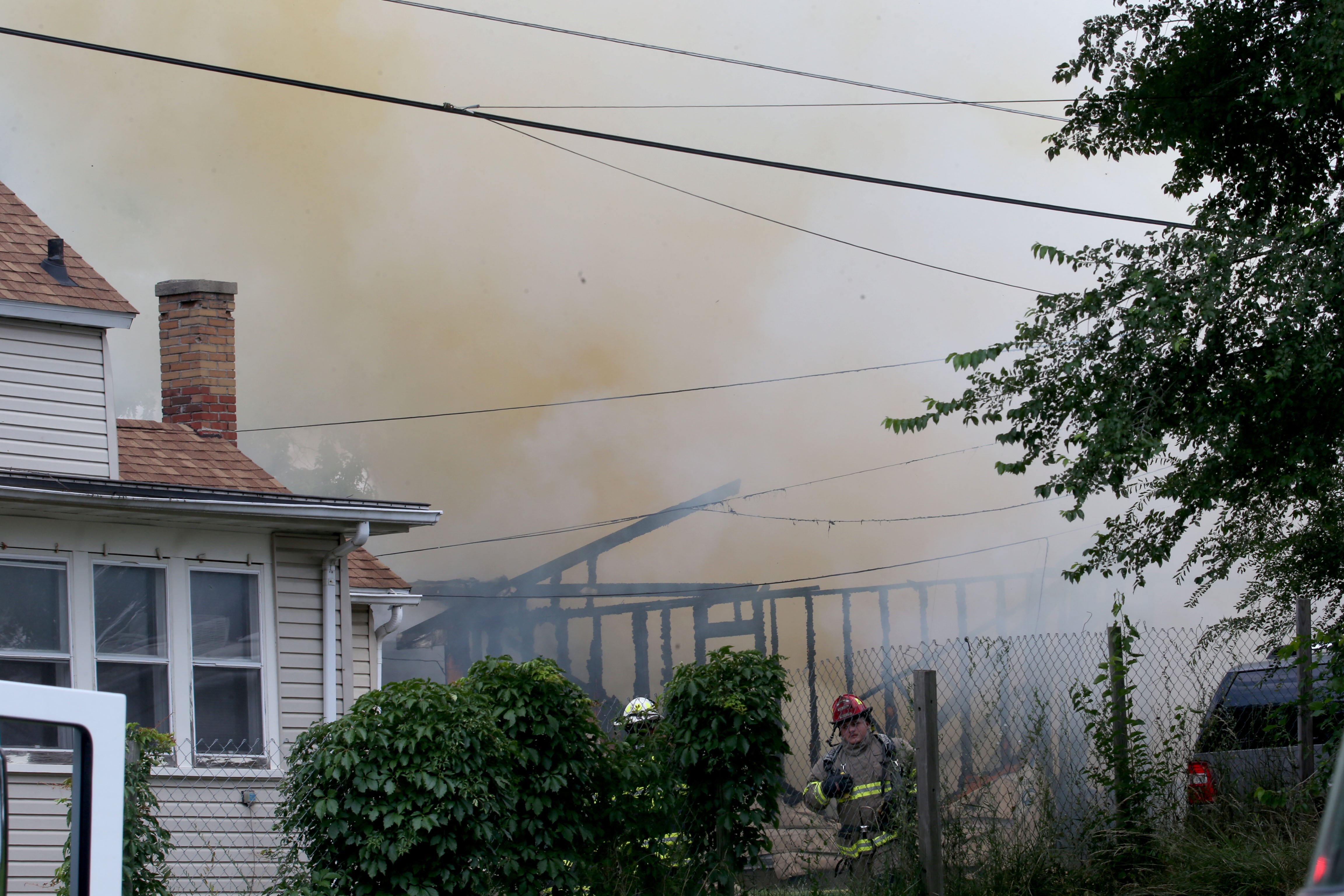 La Salle and Peru firefighters work the scene of garage fire in the 800 block of Lafayette Street on Monday, July 22, 2024. The fire began just before 1p.m. La Salle Fire and EMS along with Peru Fire department responded to the call while La Salle Police directed traffic.