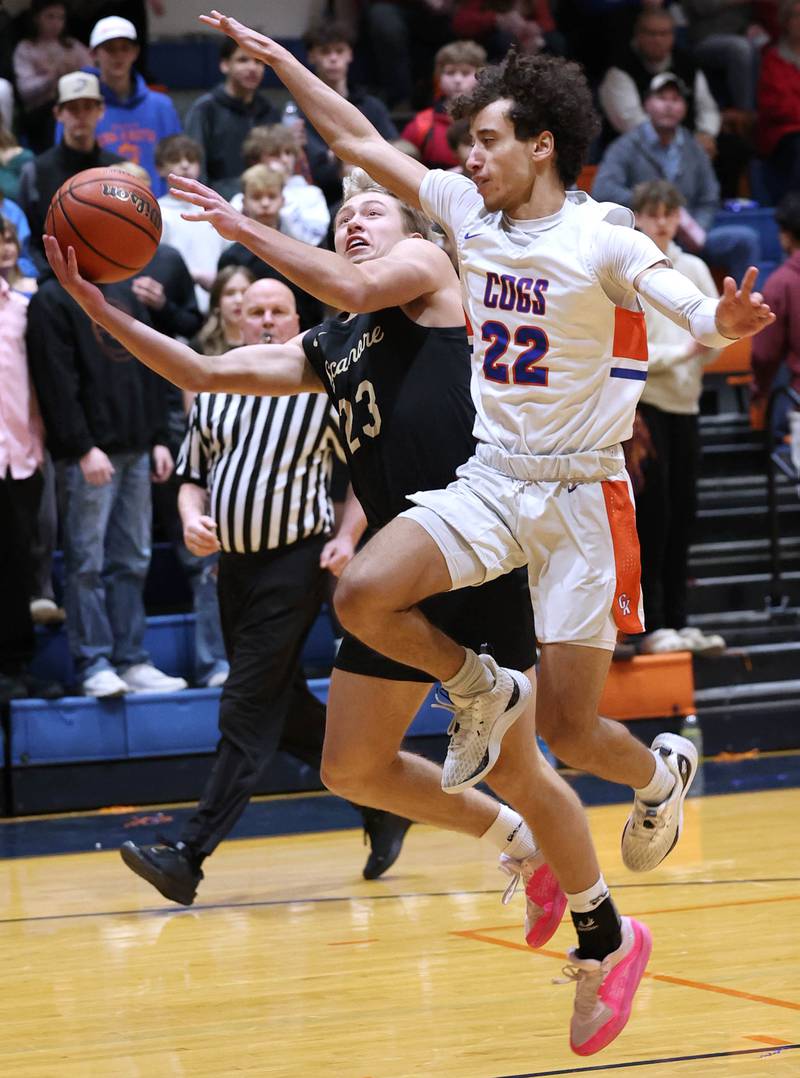 Sycamore's Carter York shoots around Genoa-Kingston's Terrell Marshall during their game Wednesday, Feb. 14, 2024, at Genoa-Kingston High School.