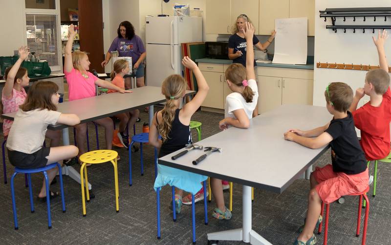 Kane County Master Gardener, Kim Corbo teaches a group of junior explorers about plants at the Town and Country Library on Friday, June 21, 2024 in Elburn.