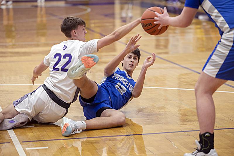 Princeton’s Tyson Phillips makes a pass while wrestling Dixon’s Bryce Feit for the ball Thursday, Dec. 21, 2023 at Dixon High School.