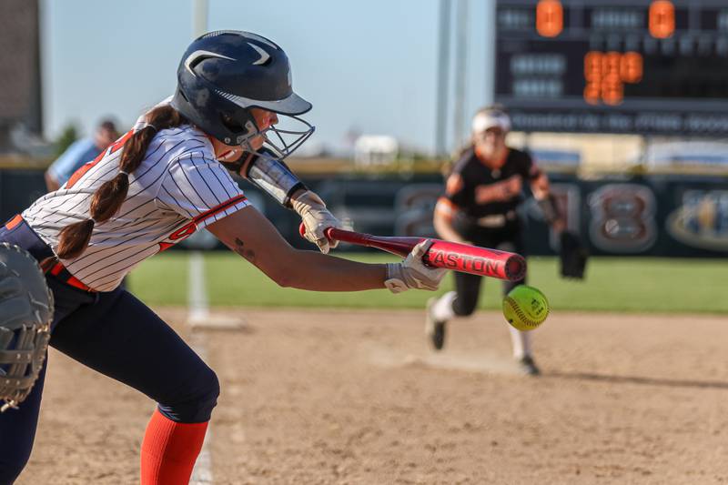 Oswego's Marissa Moffett (5) bunts during Class 4A Plainfield North Sectional semifinal softball game between Wheaton-Warrenville South at Oswego. May 29th, 2024.