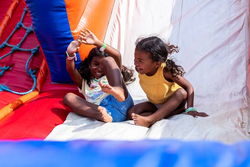 Romeoville residents Aintani and Andrea Lanczki have fun on the slide during Lockport Township Park District's Juneteenth Celebration at A.F. Hill Park on June 19, 2024.