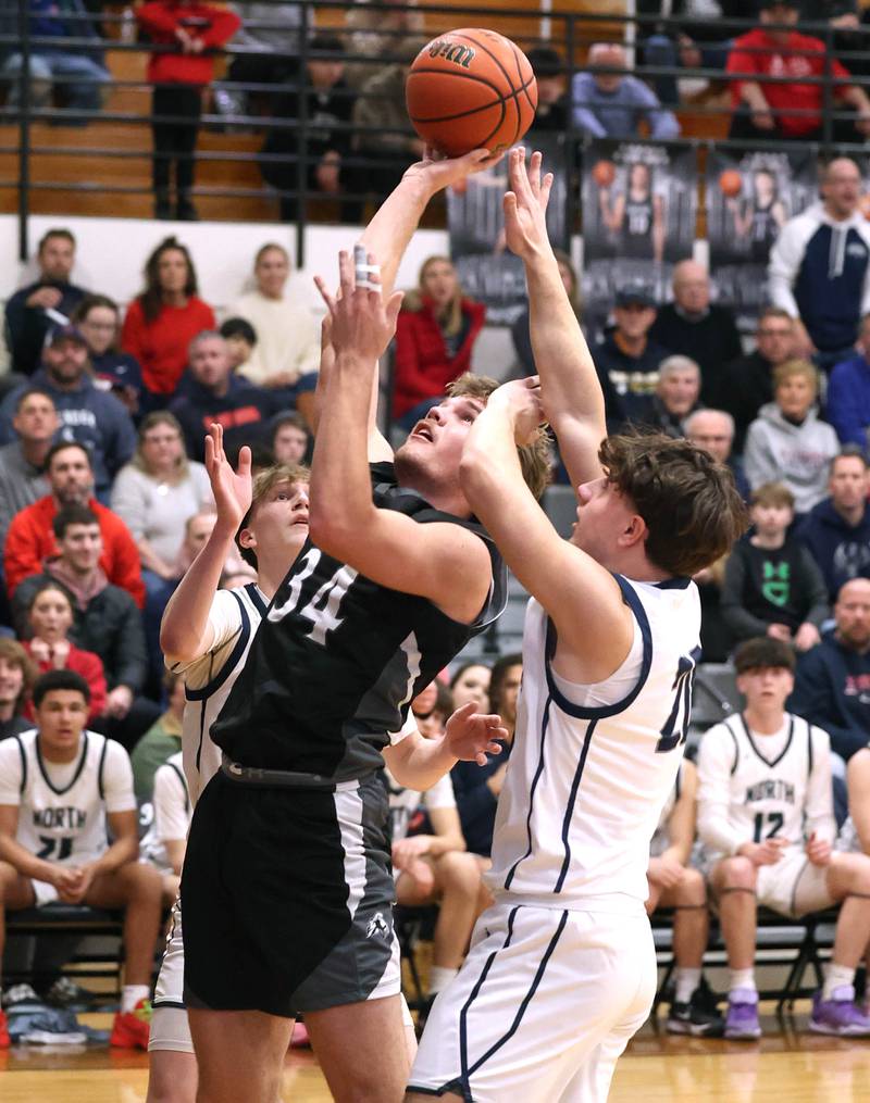 Kaneland's Parker Violett gets a layup in front of Belvidere North's Ben Bucher Wednesday, Feb. 28, 2024, during their Class 3A sectional semifinal game at Kaneland High School in Maple Park.