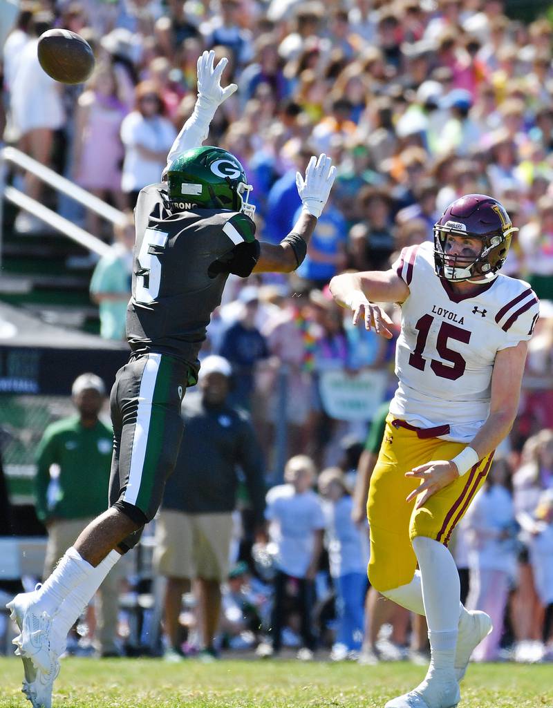 Loyola quarterback Ryan Fitzgerald (15) fires a pass past Glenbard West's Val Jones (5) during a game on September 7, 2024 at Glenbard West High School in Glen Ellyn.