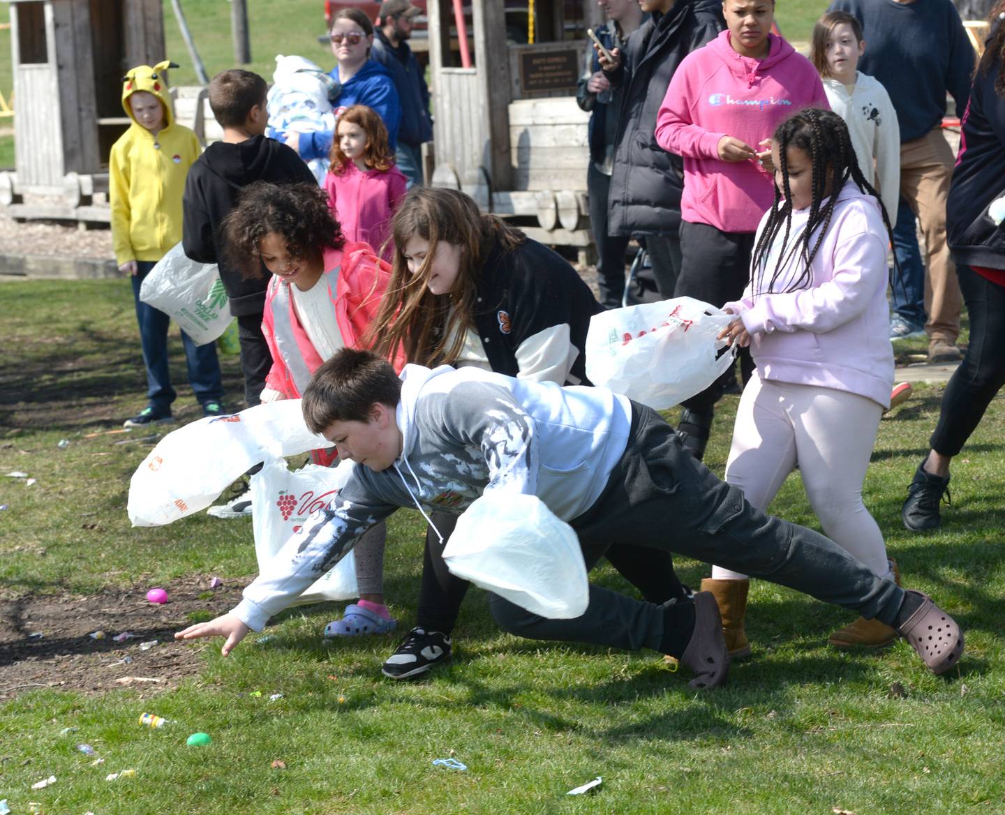 Nicholas Lakota, 11, of Freeport, dives for Easter eggs and candy as Kylee Coller, 9, and Malayah and Aliyah, Curry, 9 and 10, laugh at the start of one of the Easter egg hunts sponsored by the Forreston Lions and FABA at Memorial Park in Forreston on Saturday, March 30, 2024.