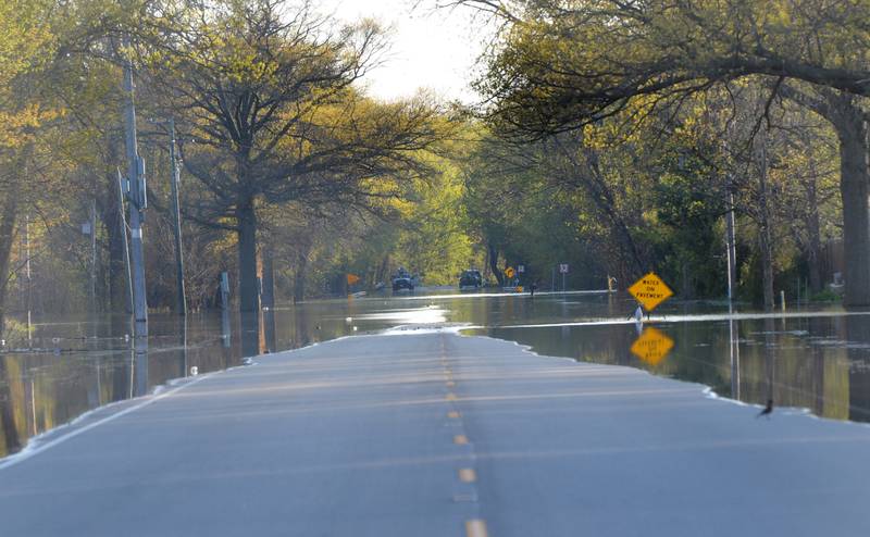 Water from the Mississippi River creeps across a section of Route 84 between Fulton and Albany on Thursday forcing traffic to be detoured around the flooded area.