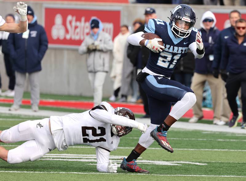 Nazareth's Lesroy Tittle breaks the tackle attempt of Joliet Catholic's Conner O’Donnell on his way to a touchdown Saturday, Nov. 25, 2023, during their IHSA Class 5A state championship game in Hancock Stadium at Illinois State University in Normal.