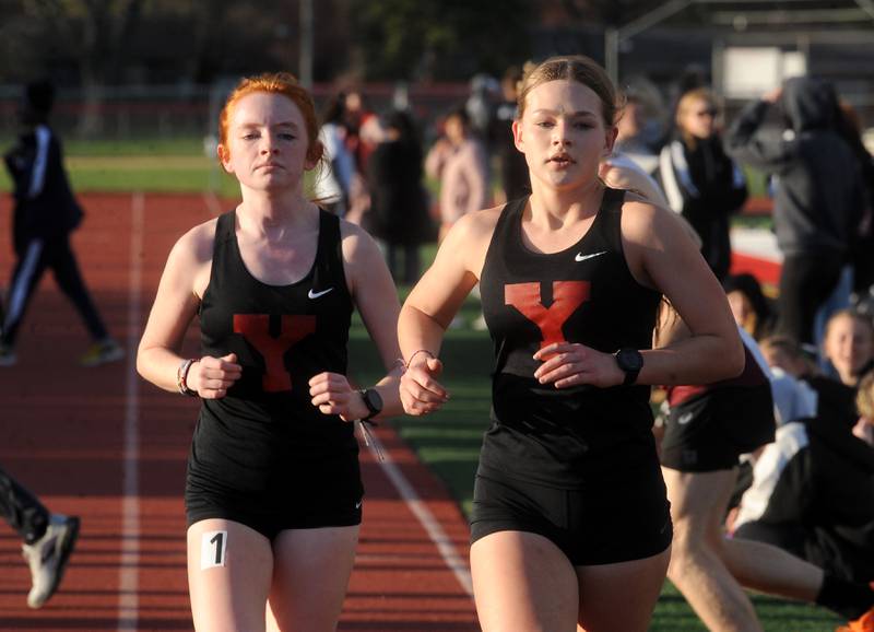 Yorkville's Sophia Keeler (right) and teammate Annabelle Reeder take a huge lead into the last lap of the 3,200-meter run, during the Matt Wulf Track and Field Invitational at Yorkville High School on Friday, April 12, 2024.
