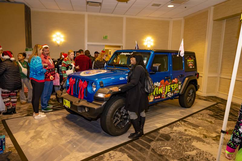 Attendees at the 2023 Jeep on the Run Toys for Tots Run Afterparty check out the raffle prize, a 2023 Jeep. Sales are now open for the 2024 raffle drawing.