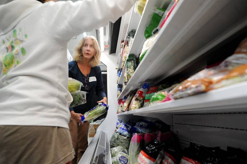 Volunteer Cynthia Bissell helps people shop for food Monday, April 25, 2022, at the Crystal Lake Food Pantry, 42 East Street, in Crystal Lake. Food pantries across McHenry County are combating both inflation and increasing need.