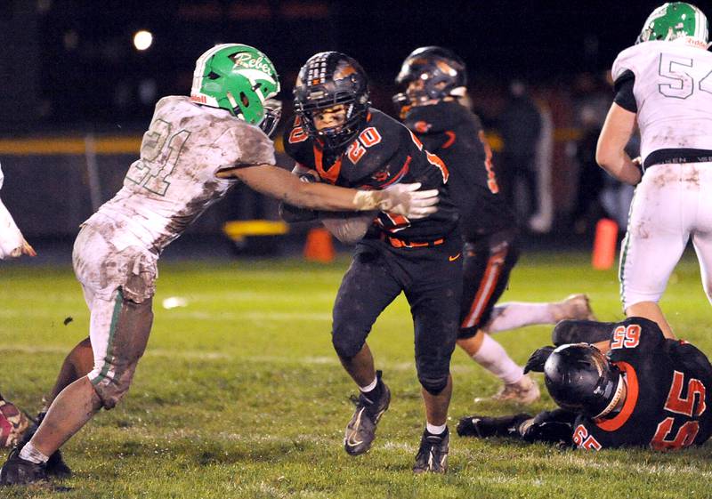 After finding some running room, Sandwich running back Diego Gomez (20) meets Ridgewood defender Julian Luna (21) during a varsity football game at Sandwich High School on Friday, Oct. 27, 2023.