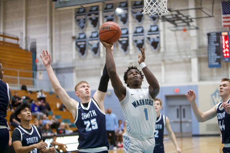 Willowbrook's Kenyon Rhodes goes in for the shot past Downer Grove South's Daniel Sveiteris  on Friday, Feb.2,2024 in Villa Park.