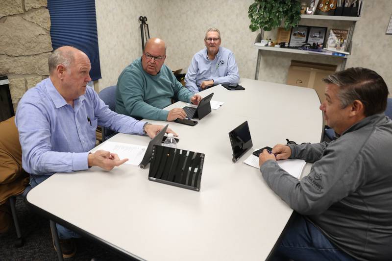 Barry Narvick, left clockwise, Bob Baish, Les Cheney and Jason Cox finish up a meeting at the Contractors Association of Will and Grundy Counties office on Wednesday, Nov. 1, 2023 in Joliet.