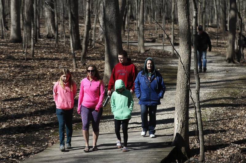 People walks between teaching stations during the McHenry County Conservation District’s annual Festival of the Sugar Maples, at Coral Woods Conservation Area, in Marengo, on Monday, March 11, 2024.