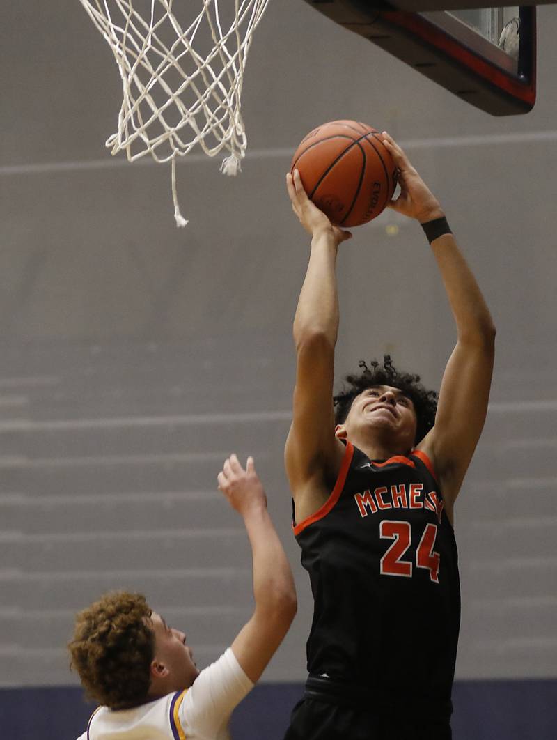 McHenry's Adam Anwar drives to the basket against Hononegah's Landon Claudy during the IHSA Class 4A Guilford Boys Basketball Sectional semifinal game on Wednesday, Feb. 28, 2024, at Rock Valley College in Rockford.