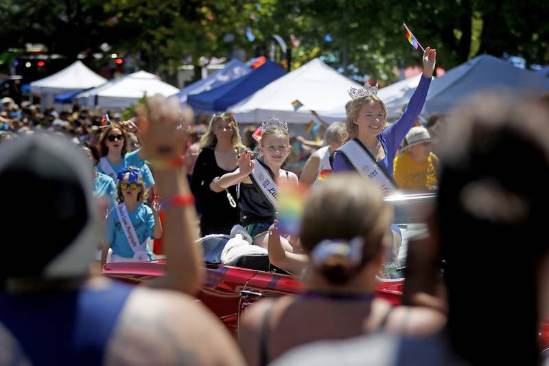 Little Miss Woodstock McKenna McAdow  and Miss Woodstock 2023 Maggie Adams  wave to the crowd during the Woodstock PrideFest Parade on Sunday, June 9, 2024, around the historic Woodstock Square.