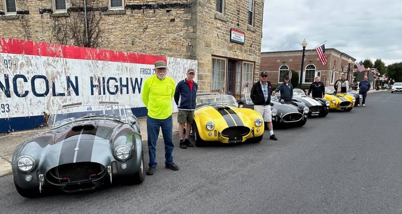 Members of the Superformance Owners Association pose in front of the Lincoln Highway Association's national headquarters Friday in Franklin Grove.