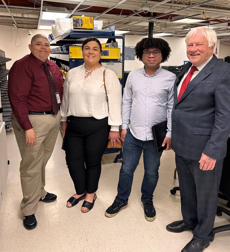 Kane County Director of Elections Raymond Esquivel (left), Katie Smith, Minneapolis Assistant City Clerk-Director of Elections and Voter Services and Mail Manager Jon Martin and Kane County Clerk John Cunningham see the automated equipment during a tour at the clerk’s office in Geneva.