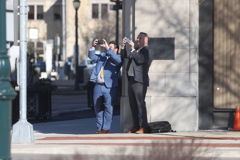 A couple business stop to take photos of the external demolition of the old Will County Courthouse on Friday, Feb. 9th 2024 in Joliet.