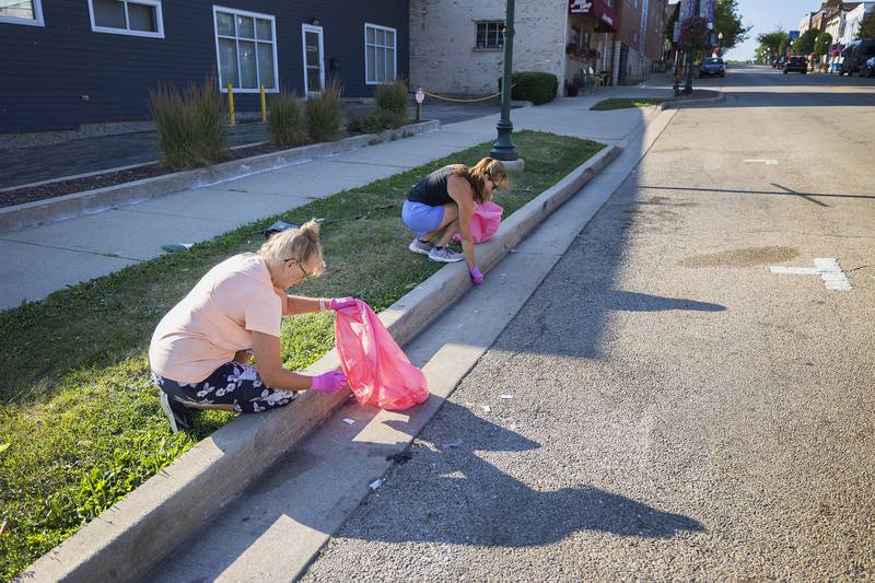 Deb Cashman (left) and Paula Sherman get to work cleaning the streets of Dixon Thursday, July 6, 2023. Dixon Chamber’s Beautify Dixon committee organizes a monthly cleanup to keep the city spiffy.