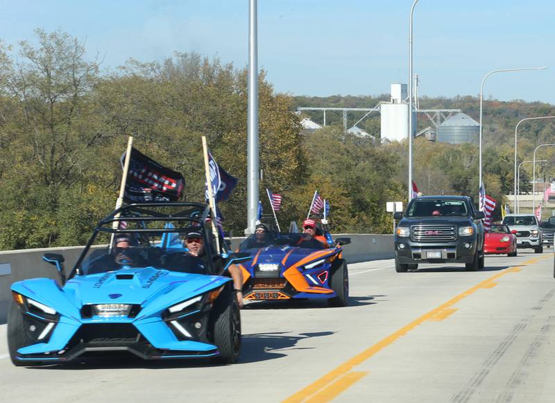 Cars carry Trump 2024 flags while leading others in the Trump Caravan over the Illinois Route 178 on Saturday, Oct. 19, 2024 in Utica.