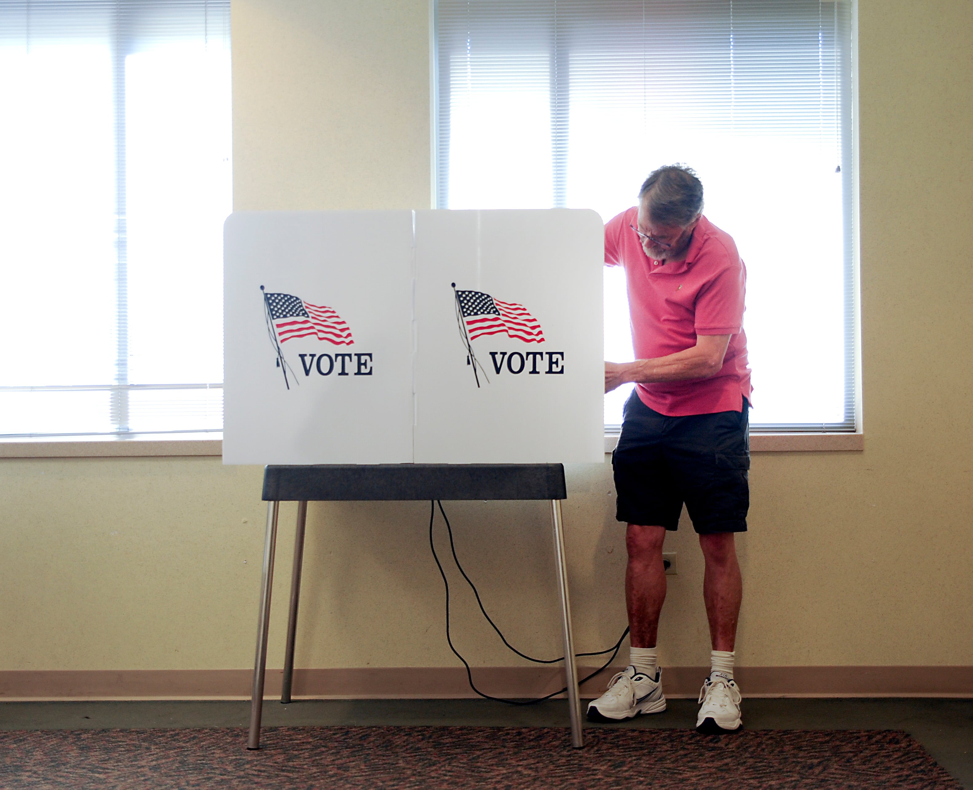 Election Judge Steve Krause opens up the voting machines Friday, June 24, 2022, at the McHenry County Administration Building, 667 Ware Road in Woodstock. Polls are open from 6 a.m until 7 p.m. today for people to cast their ballot in the in the primary election.