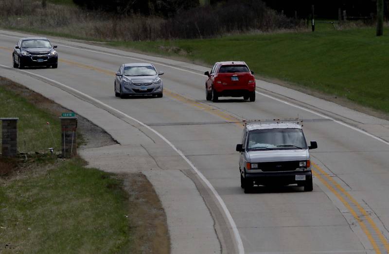 Vehicles travel U.S. Route 14 on Tuesday, April 26, 2022, near West South Street in Woodstock. The Illinois Department of Transportation is resurfacing a nearly six-mile stretch of U.S. Route 14, running west from Hughes and Hartland roads to IL Route 47. The road is a popular route from Woodstock to Harvard and into Wisconsin.