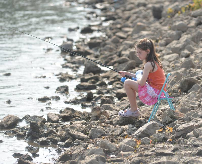 Lily Diaz, 9, of Prophetstown watches her line as she fishes at the 17th Dick Brown Fishing Derby for kids at Prophetstown State Park on Saturday.