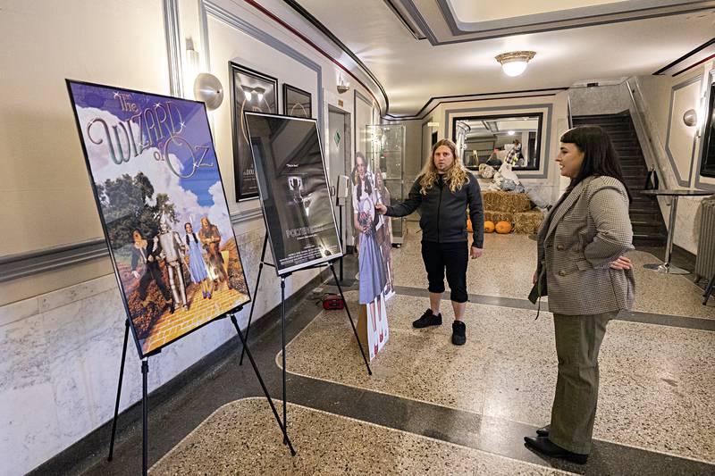 Technical director Scott Shipp and board member Jessica Dempsey arrange posters in the lobby of The Dixon Thursday, Oct. 19, 2023. The theater is showing films The Wizard of Oz and Poltergeist this weekend. Organizers are expecting to show movies on a regular basis going forward.