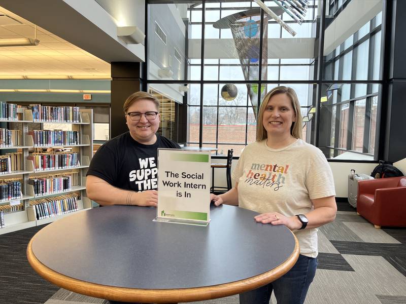Downers Grove social work interns Andi Voinovich (left) and Dawn Davis help library patrons meet various needs including temporary housing, emergency resources, job concerns and counseling services.