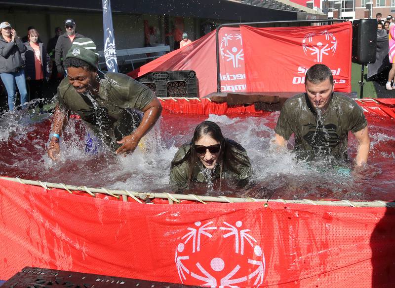 Representatives from the Sycamore Police Department emerge from the water on a cold and windy Saturday, Feb 17, 2024, during the Huskie Stadium Polar Plunge at Northern Illinois University in DeKalb. The Polar Plunge is the signature fundraiser for Special Olympics Illinois.