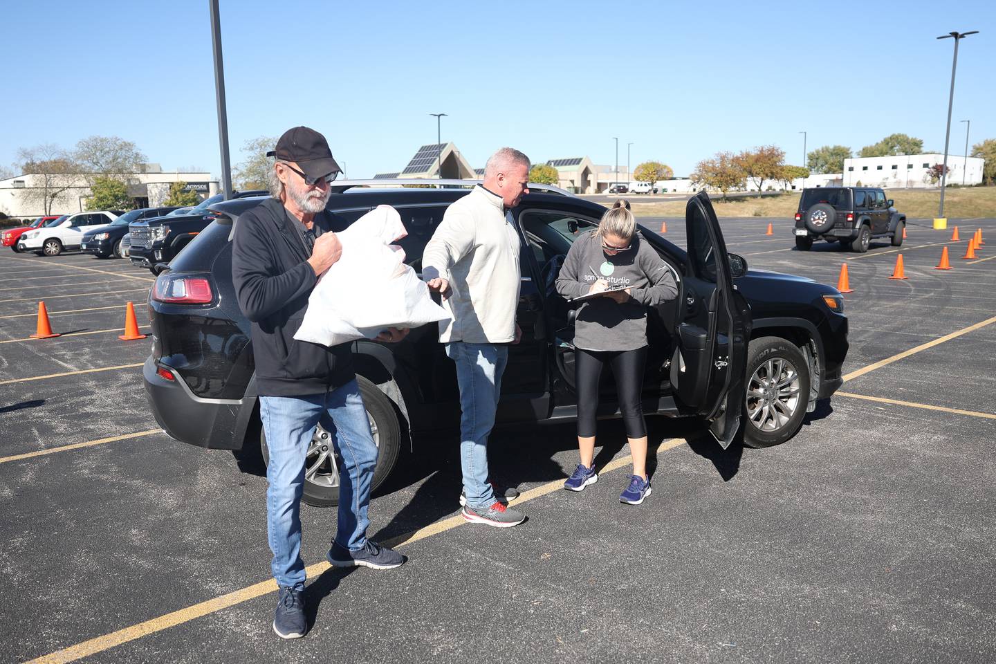 A woman drops off donates to be delivered to Bristol Motor Speedway, Tennessee for the victims of Hurricanes Helene and Milton at the City of Joliet and Cadence Cares Foundation relief drive on Saturday, Oct. 19, 2024 in Joliet.