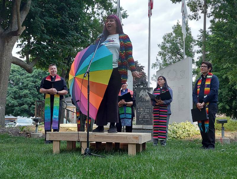 Pasha Ripley of the Parasol Patrol speaks Friday, June 7, 2024, at Washington Square in Ottawa, in memory of Nex Benedict, a 16-year-old non-binary American high school student who died of suicide by drug overdose the day after a physical altercation in the girls' restroom of their high school.