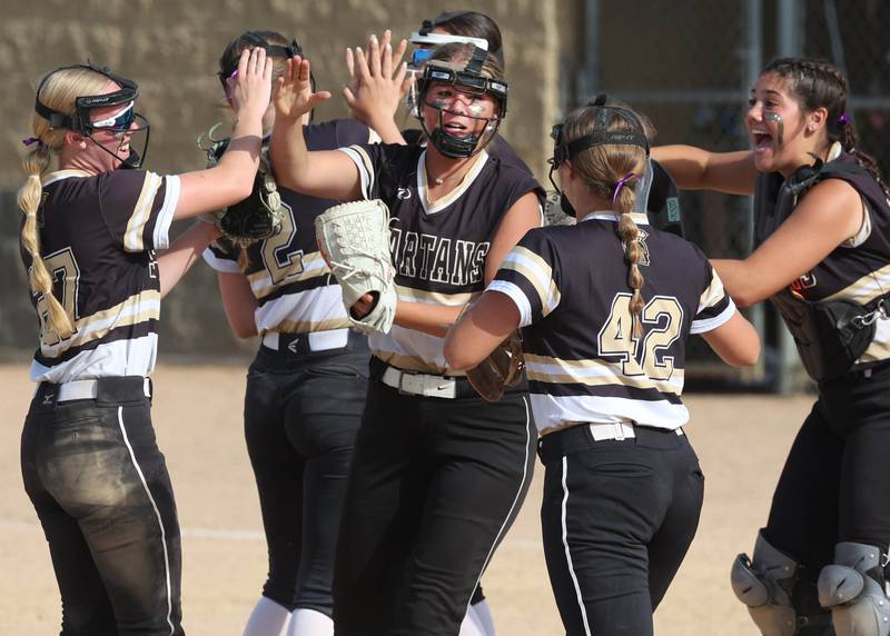 Sycamore players meet on the mound after turning a double play during their Class 3A sectional final against Prairie Ridge Friday, May 31, 2024, at Sycamore High School.