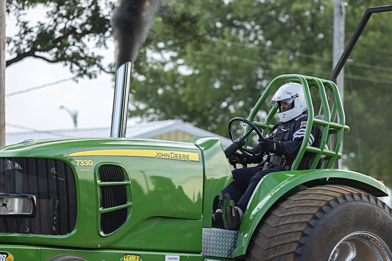 Gene Weerda eyes a full pull at the Badger State Tractor Pullers event Wednesday, August 9, 2023 at the Carroll County fair.