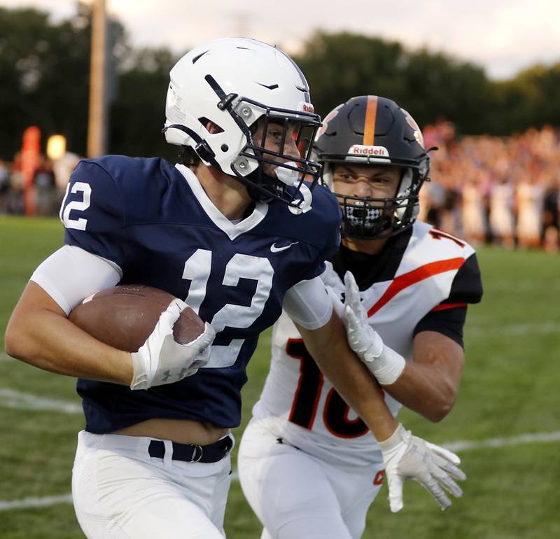 Cary-Grove's Landon Barnett priest to avoid being tackles by Crystal Lake Central's Ben Freese after a long run during a Fox Valley Conference football game on Friday, Sept. 6, 2024, at Cary-Grove High School in Cary.