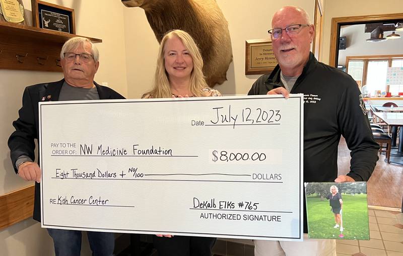 On July 12, 2023, Roger Finnan (right) and Jerry Evans (left) presents Northwestern Medicine Kishwaukee Cancer Center employee Michelle Scheri (middle) with an $8,000 check for the cancer center.