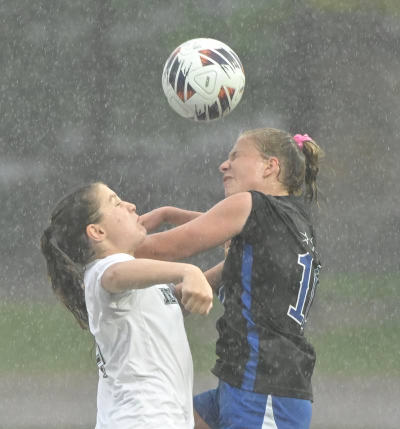 St. Charles North High School’s Chloe Kirsten, right, and Winnetka New Trier High School’s Noa Boeing compete in the rain for a header in the IHSA Class 3A championship game at North Central College in Naperville on Saturday, June 1, 2024.