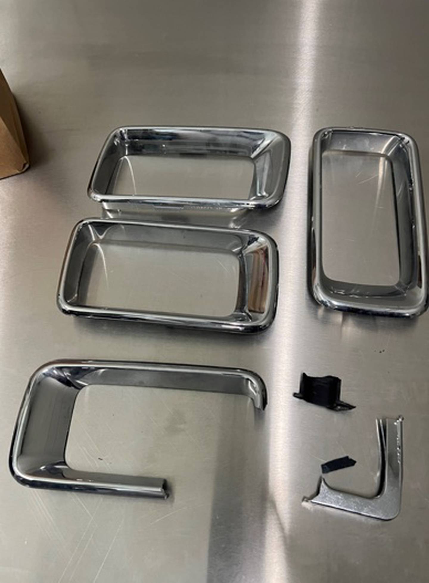 Four silver rectangle grill pieces from the dark-colored Jeep Grand Cherokee that Crest Hill police officials believe is involved in a deadly crash last Saturday that killed two pedestrians.