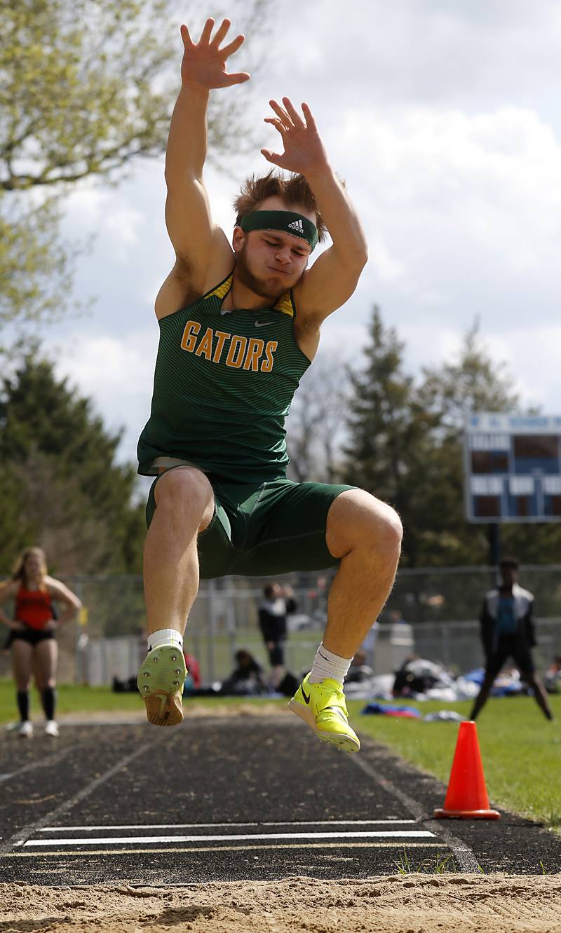 Crystal Lake South’s Nathan Van Witzenburg competes in the long jump Friday, April 21, 2023, during the McHenry County Track and Field Meet at Cary-Grove High School.