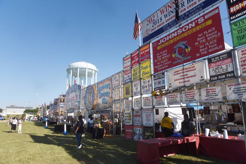 Joe Lewnard/jlewnard@dailyherald.com
Seven vendors are lined up during the opening day of Ribfest at the DuPage County Fairgrounds in Wheaton Friday.