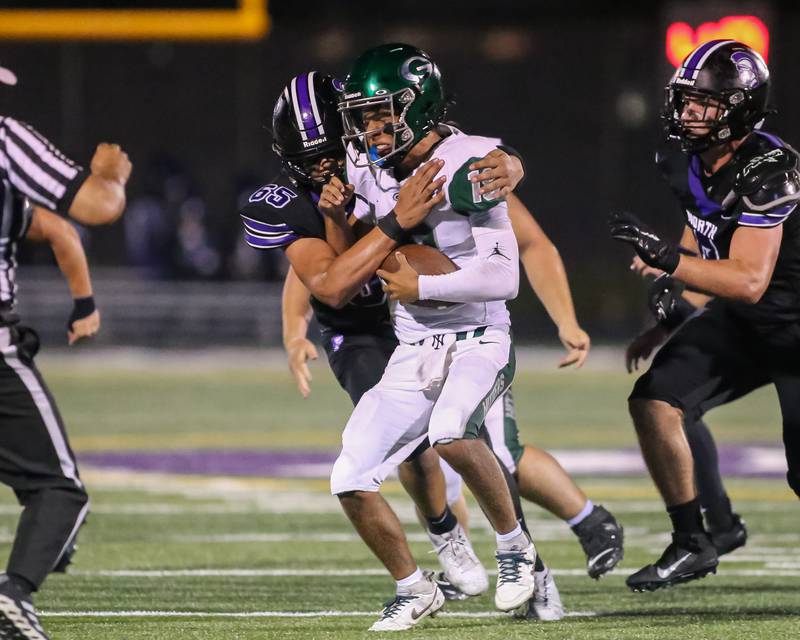 Downers Grove North's Aiden Solecki (65) sacks Glenbard West's Oliver Valdez (18) during a football game between Glenbard West at Downers Grove North on Friday, Sept 13th, 2024  in Downers Grove.