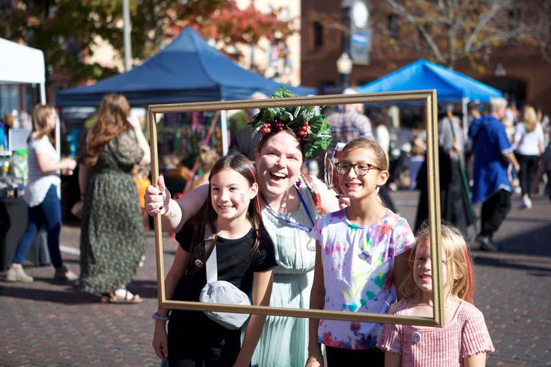 Attendees gather for a framed photo at the Witches and Wizards of Woodstock on Sunday, Oct. 20,2024 in Woodstock.