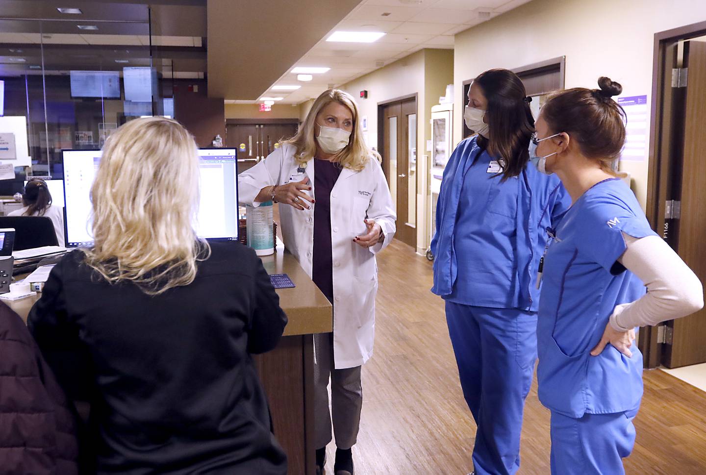 Kim Armour, a Vice President and Chief Nurse Executive at Northwest Medicine Huntley Hospital, talks with members of the hospital’s emergency department patient care team Wednesday, Feb. 16, 2022, while making rounds at the hospital.