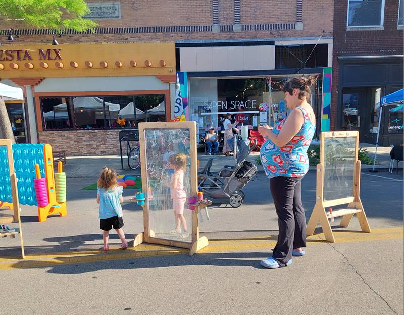 Children play games and create their own art Friday, May 17, 2024, at the opening Third Friday of the season in downtown Ottawa.