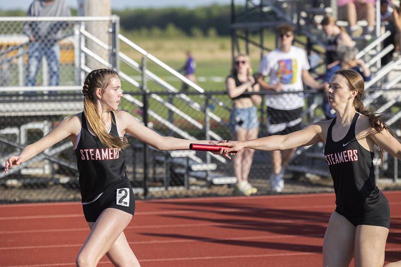 Fulton’s Brooklyn Brennan hands the baton to Jasmine Moreland in the 4x800 Wednesday, May 10, 2023 at the class 1A Erie girls track sectional.