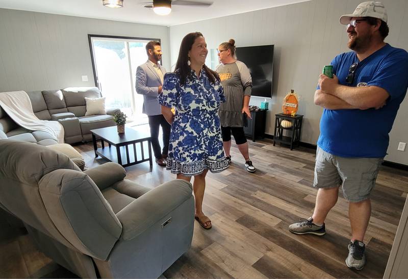 Ottawa Friendship House executive director Tony Barrett (back, left) gives a tour of the newly remodeled home in Ottawa that is the latest in its commitment to Intermittent Community Integrated Living Arrangements.